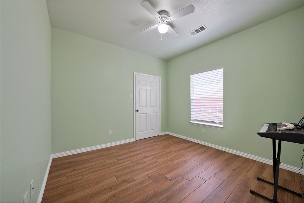 2410 Carleta Street Dallas, TX 75253 - Photo 20 of 29 a view of empty room with wooden floor and fan