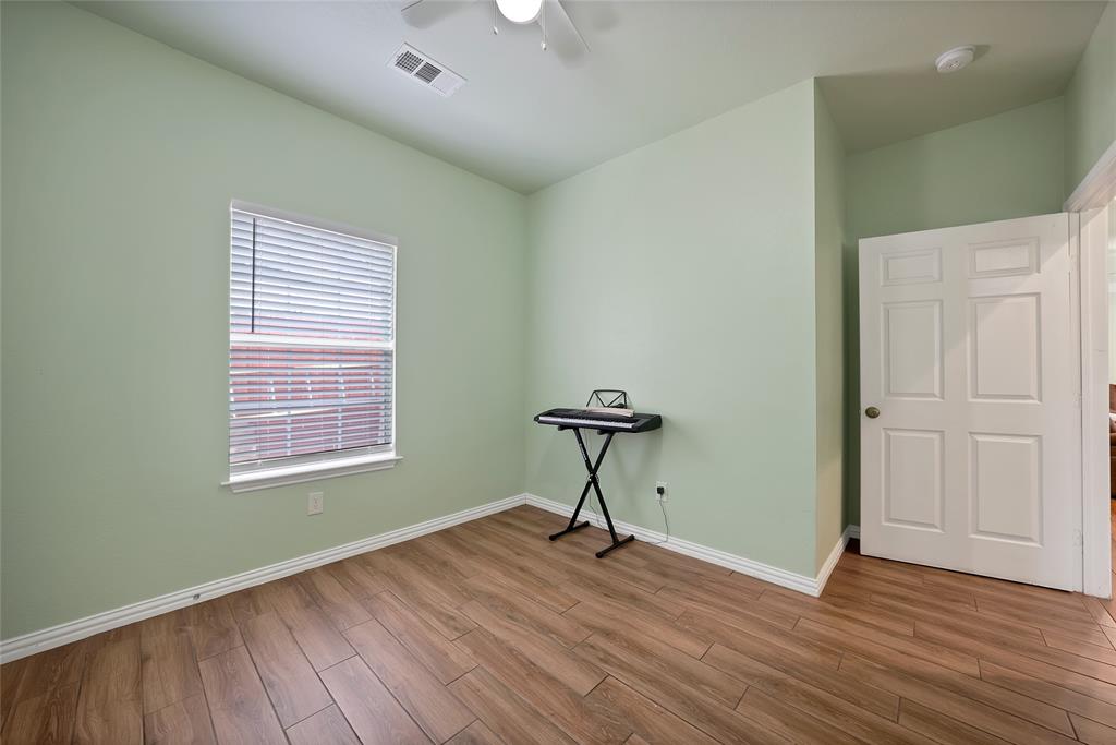 2410 Carleta Street Dallas, TX 75253 - Photo 22 of 29 a view of an empty room with wooden floor and a window