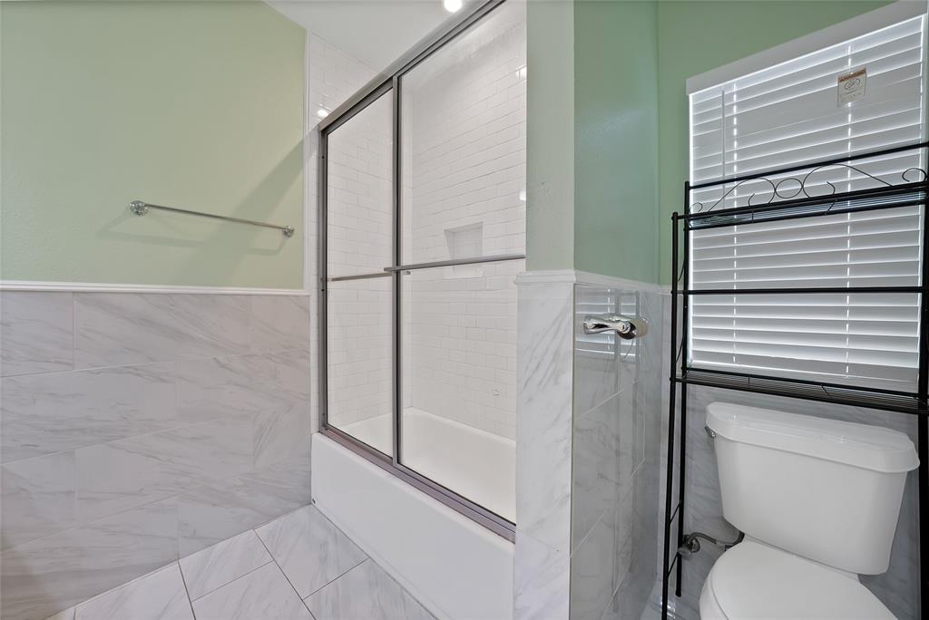 2410 Carleta Street Dallas, TX 75253 - Photo 26 of 29 a bathroom with a toilet and a shower