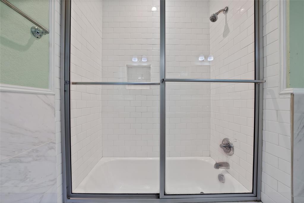 2410 Carleta Street Dallas, TX 75253 - Photo 27 of 29 a bathroom with a glass shower door