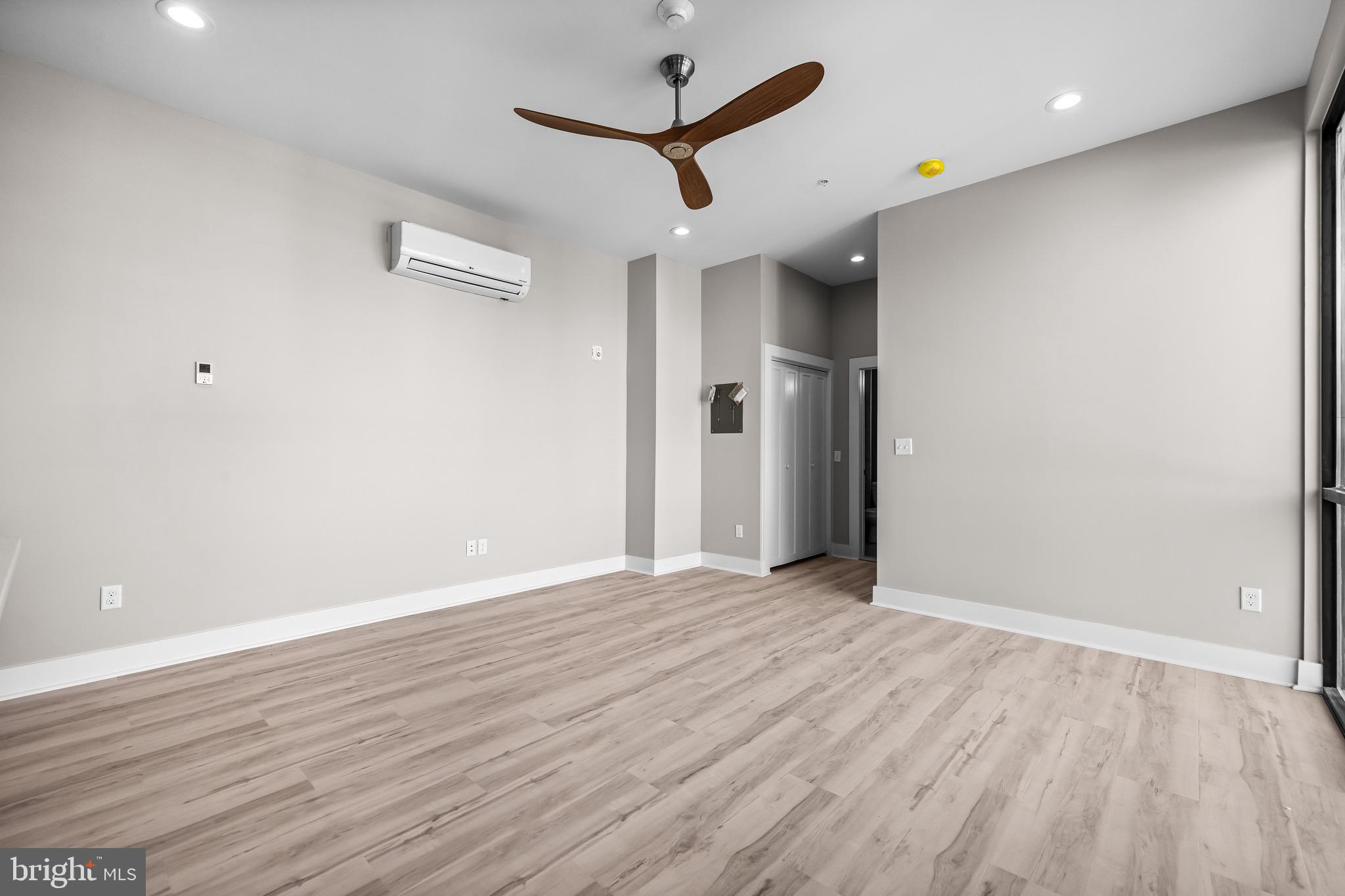 400 South Conkling Street, Unit 3 Baltimore, MD 21224 - Photo 8 of 18 an empty room with wooden floor and a ceiling fan