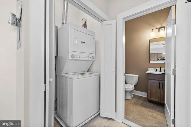 a bathroom with a toilet sink and a mirror