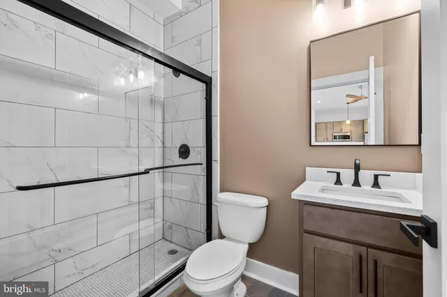 a bathroom with a sink toilet and shower