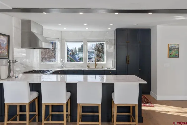 a dining room with a table chairs and kitchen view