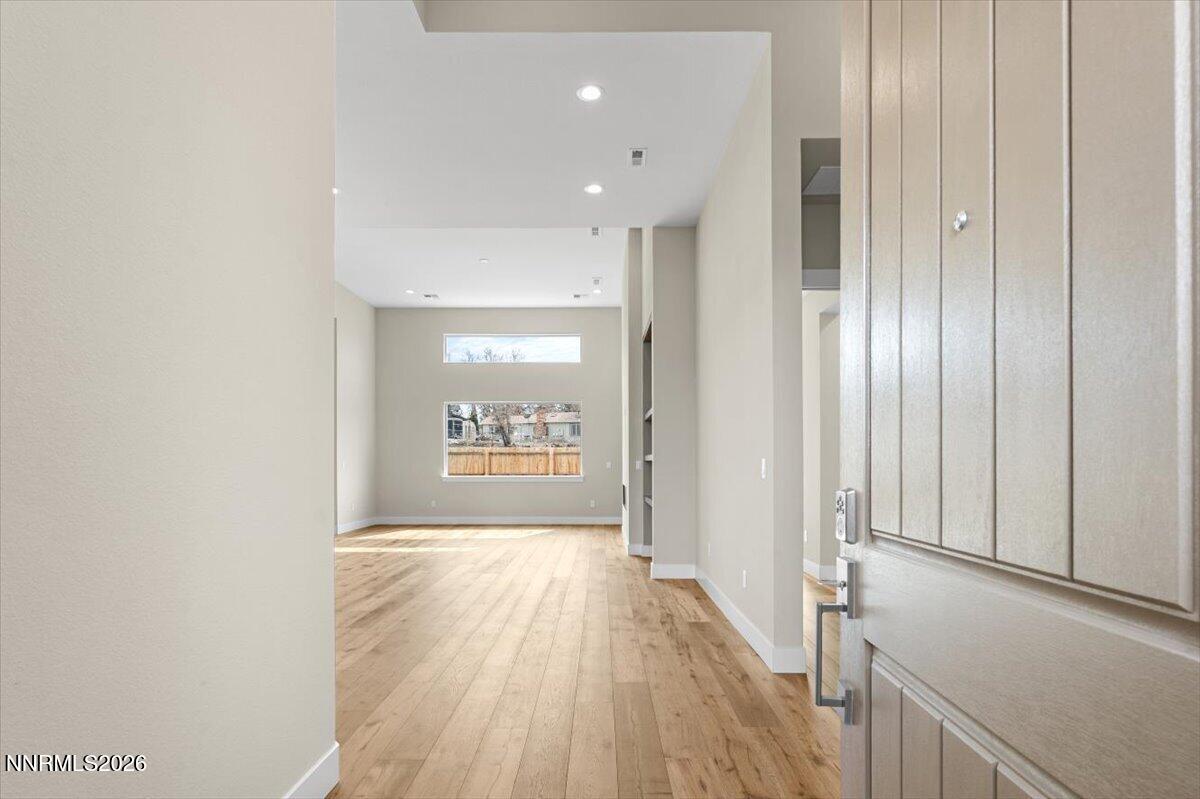 2982 Saddle Peak Drive Reno, NV 89521 - Photo 22 of 98 a view of a hallway with wooden floor and a bathroom