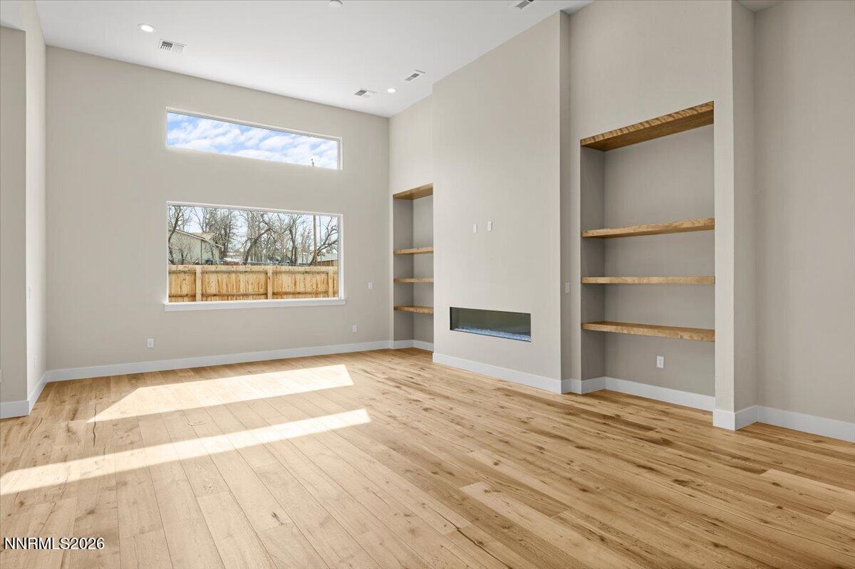 2982 Saddle Peak Drive Reno, NV 89521 - Photo 32 of 98 a view of an empty room with window and wooden floor
