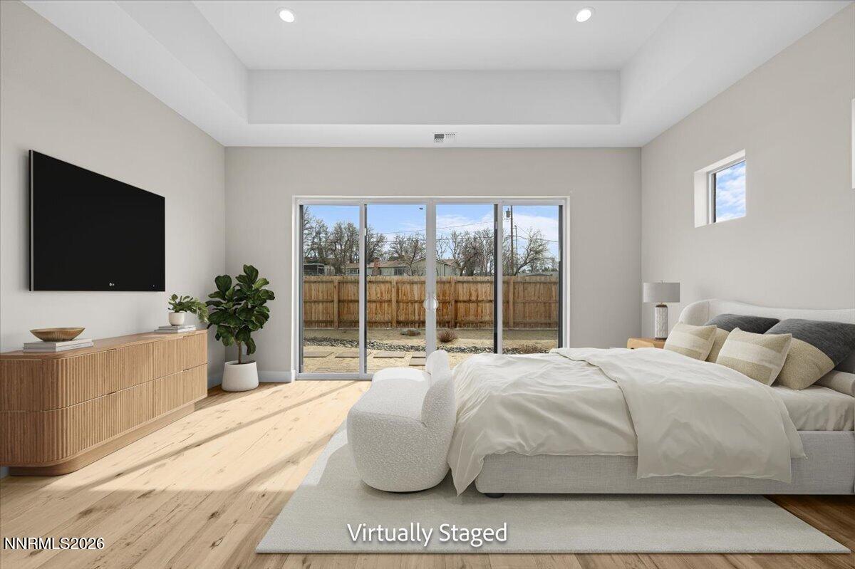 2982 Saddle Peak Drive Reno, NV 89521 - Photo 51 of 98 a bedroom with a large bed and a flat screen tv