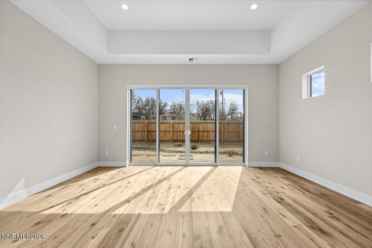 2982 Saddle Peak Drive Reno, NV 89521 - Photo 60 of 98 a view of an empty room with wooden floor and a window