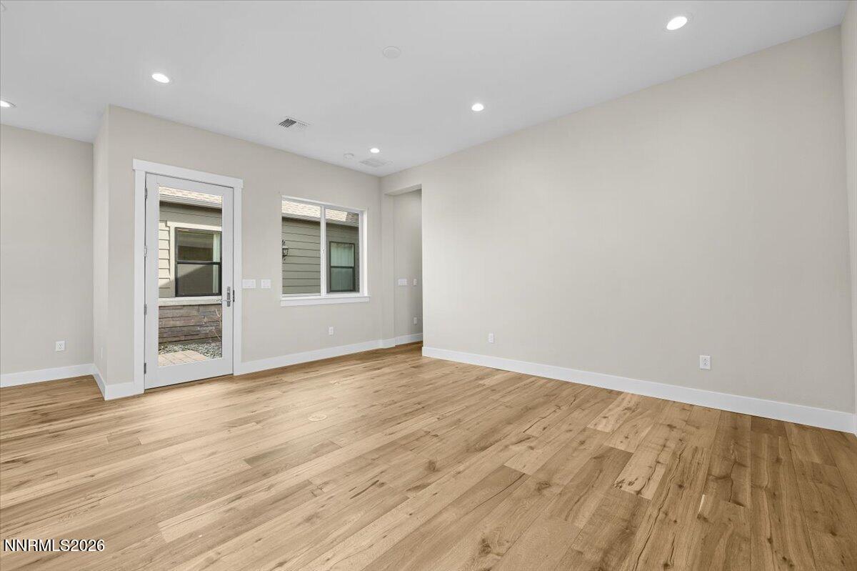 2982 Saddle Peak Drive Reno, NV 89521 - Photo 70 of 98 an empty room with wooden floor and windows