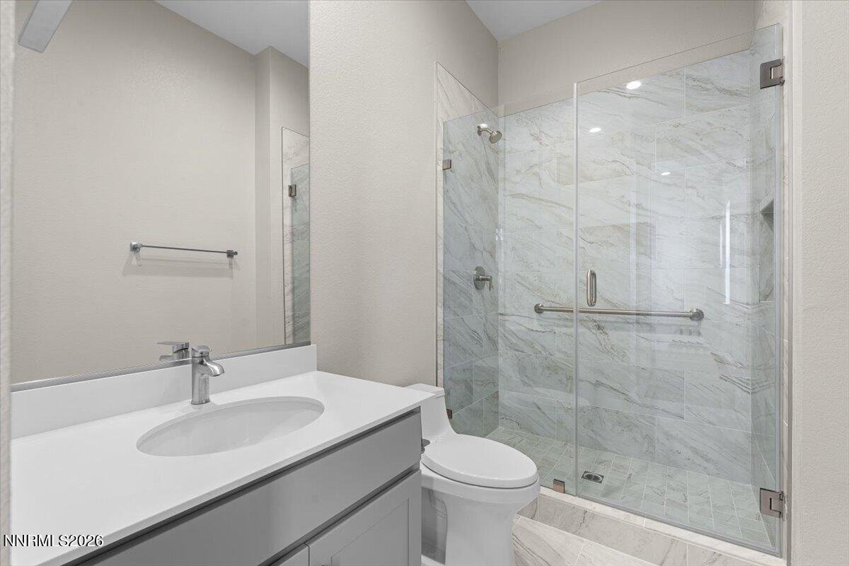 2982 Saddle Peak Drive Reno, NV 89521 - Photo 75 of 98 a bathroom with a sink toilet a mirror and shower