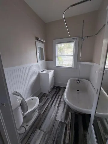 a bathroom with a sink mirror and toilet