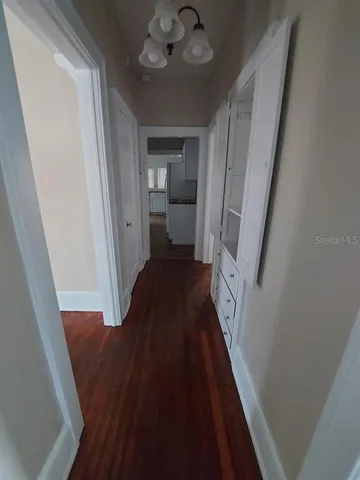 a view of a hallway view with wooden floor and staircase