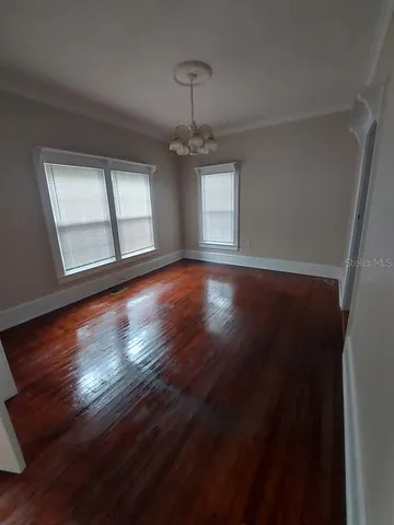 a view of wooden floor and windows in a room