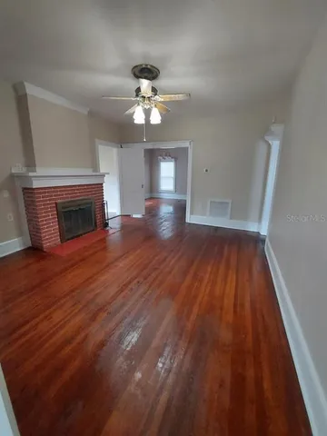 wooden floor in an empty room with a fireplace