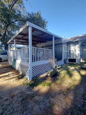 a view of a backyard with a small cabin and chair