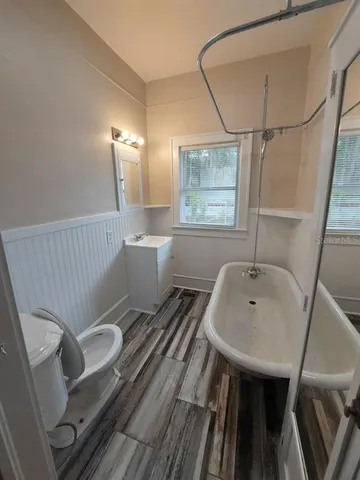 a bathroom with a sink a toilet and bathtub