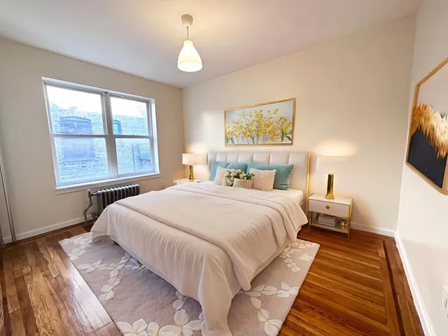 a bedroom with beds and a window