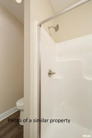 an empty room with windows and ceiling fan