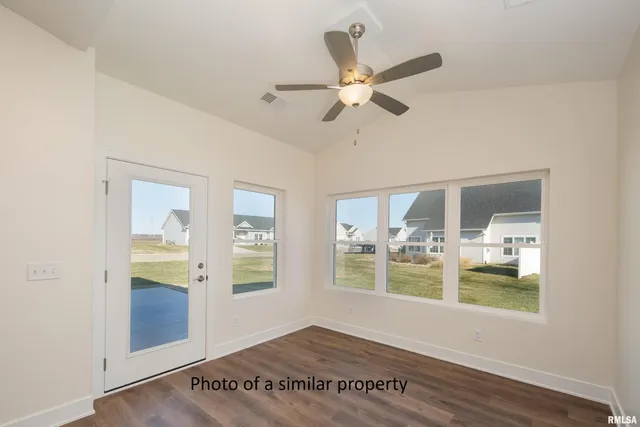 a view of a room with wooden floor and ceiling fan