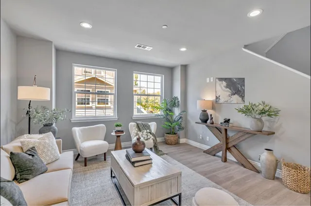 a living room with furniture and a potted plant