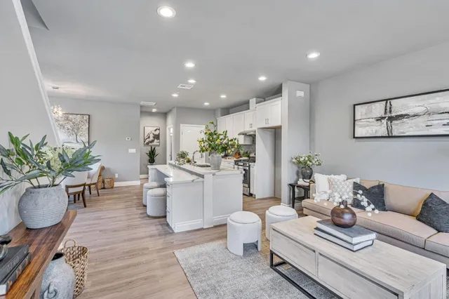 a living room with furniture and flowers
