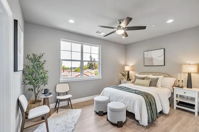 a bedroom with a bed and a chair