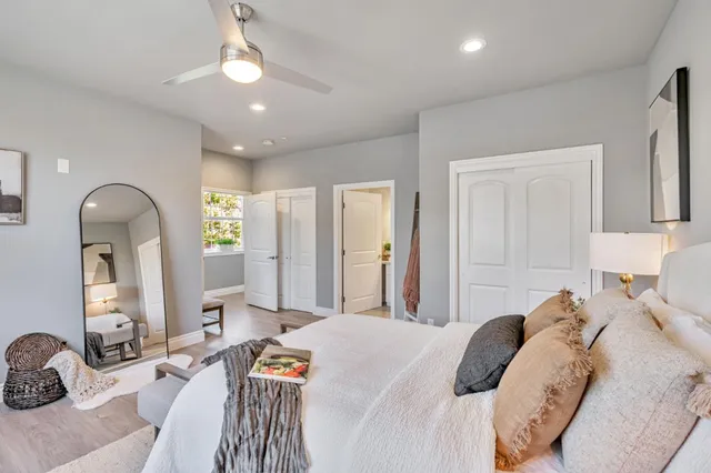 a bedroom with a bed couch and dresser