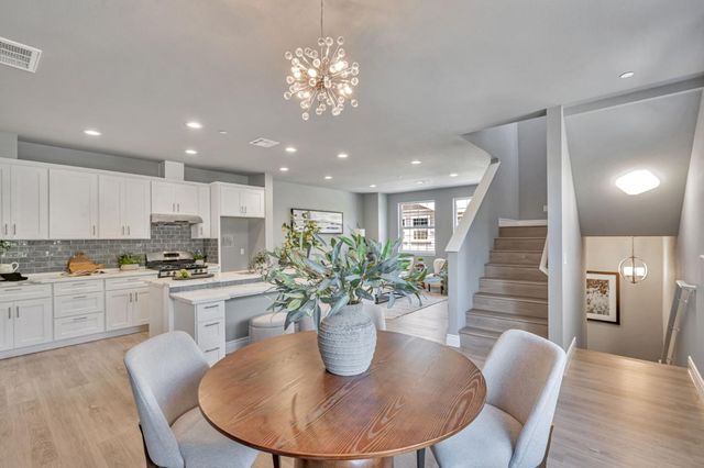a kitchen with a table and chairs