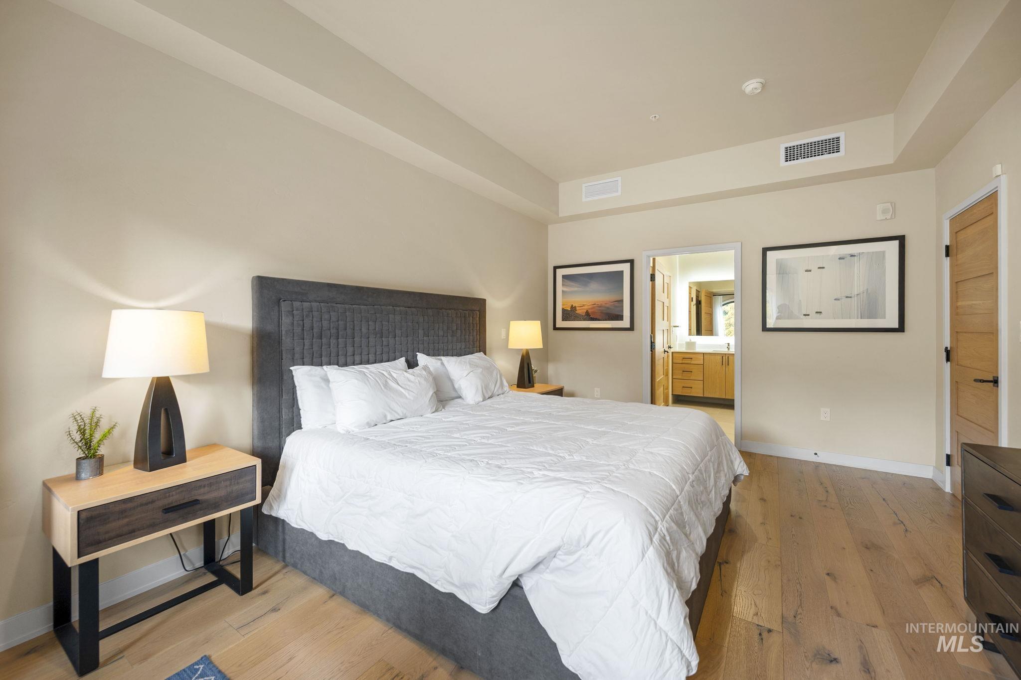780 Village Drive, Unit 505 Donnelly, ID 83615 - Photo 15 of 33 Bedroom featuring light wood-type flooring and ensuite bathroom