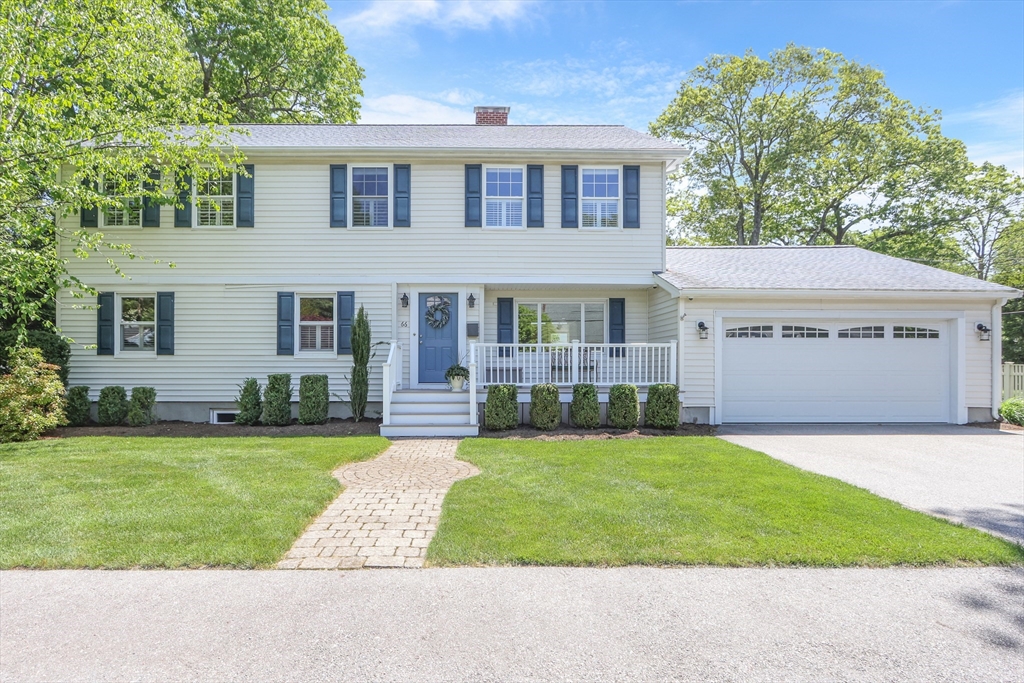 66 Avalon Road Needham, MA 02492 - Photo 1 of 39 a front view of a house with a garden and yard