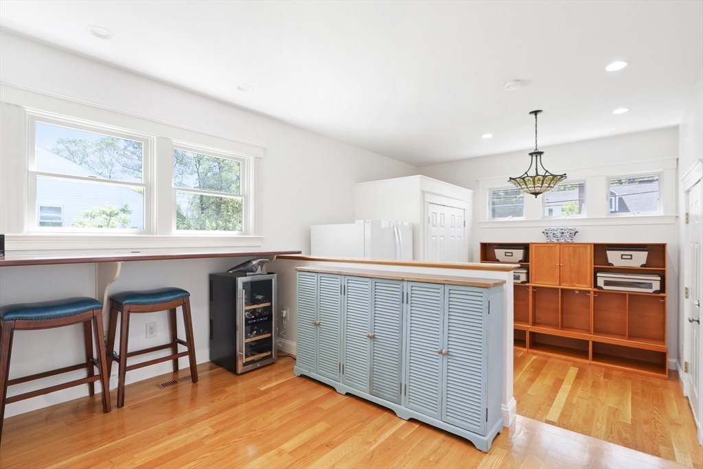 66 Avalon Road Needham, MA 02492 - Photo 18 of 39 a kitchen with stainless steel appliances granite countertop a stove a sink dishwasher and a microwave oven with wooden floor