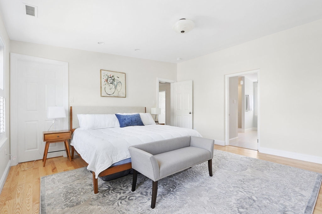 66 Avalon Road Needham, MA 02492 - Photo 22 of 39 a spacious bedroom with a bed and a table