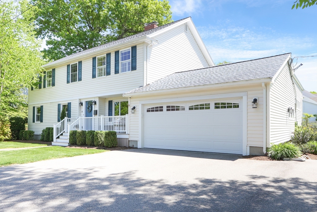 66 Avalon Road Needham, MA 02492 - Photo 3 of 39 a front view of a house with a yard and garage