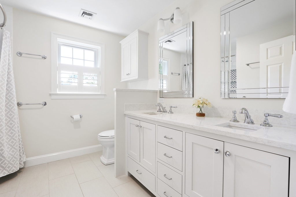 66 Avalon Road Needham, MA 02492 - Photo 31 of 39 a bathroom with double sink a toilet and a window