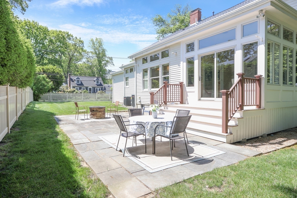 66 Avalon Road Needham, MA 02492 - Photo 37 of 39 a view of a patio with table and chairs with plants and wooden fence