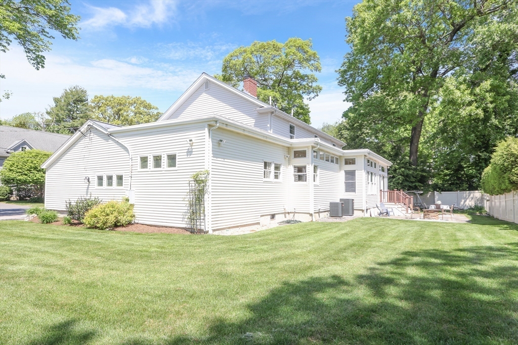 66 Avalon Road Needham, MA 02492 - Photo 38 of 39 a view of a white house with a big yard and potted plants