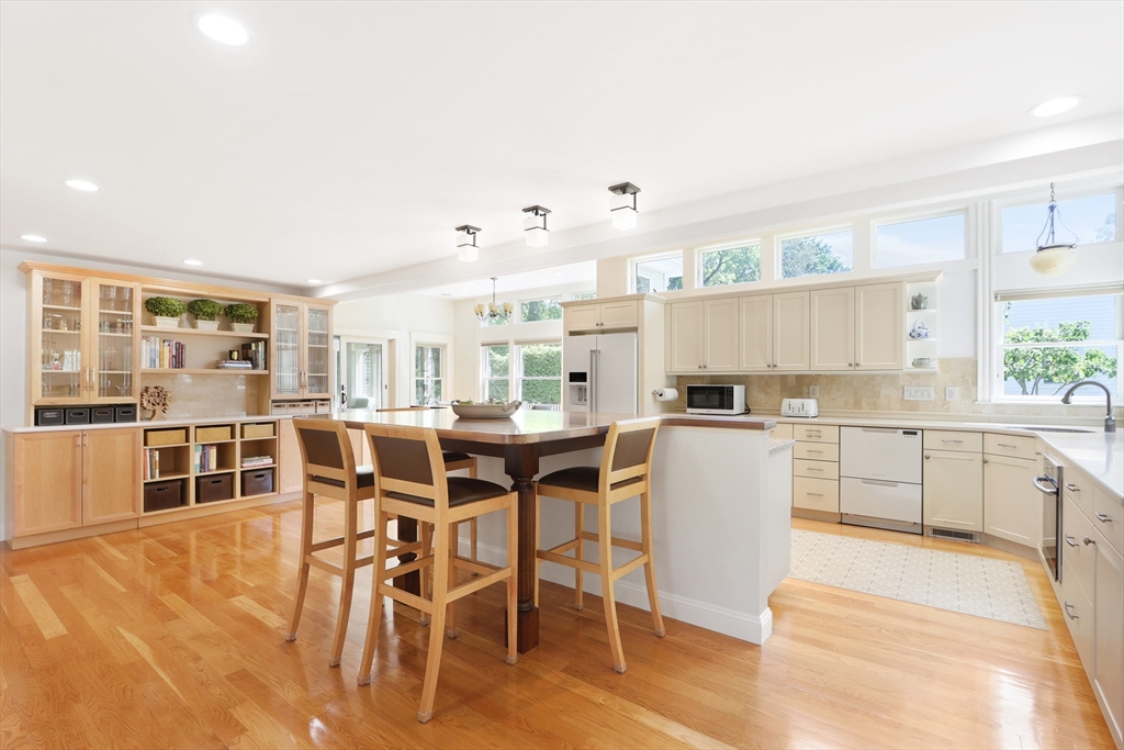 66 Avalon Road Needham, MA 02492 - Photo 4 of 39 a kitchen with a table chairs stove and cabinets