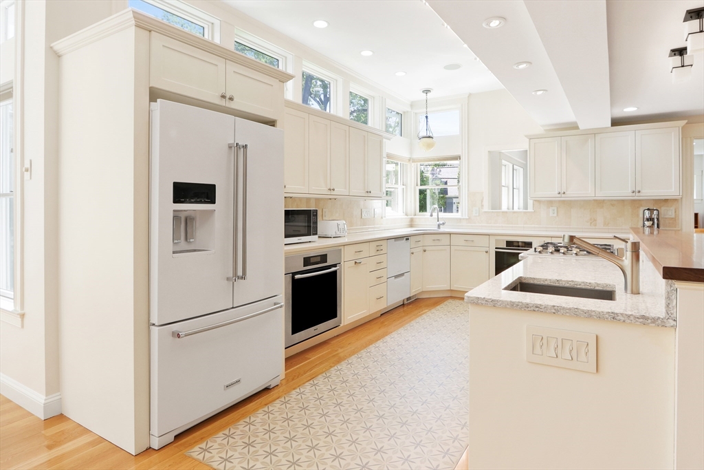 66 Avalon Road Needham, MA 02492 - Photo 6 of 39 a kitchen with white cabinets and white appliances
