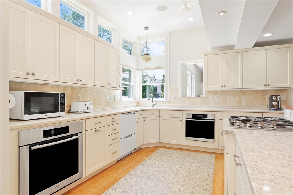 66 Avalon Road Needham, MA 02492 - Photo 8 of 39 a kitchen with stainless steel appliances granite countertop a stove a sink and white cabinets