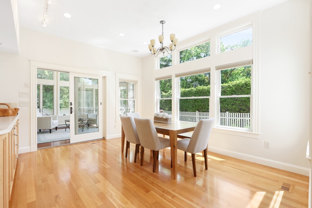 66 Avalon Road Needham, MA 02492 - Photo 10 of 39 a dining room with wooden floor a chandelier a glass table and chairs
