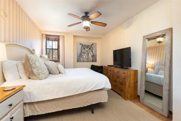 a bedroom with a bed and a flat screen tv