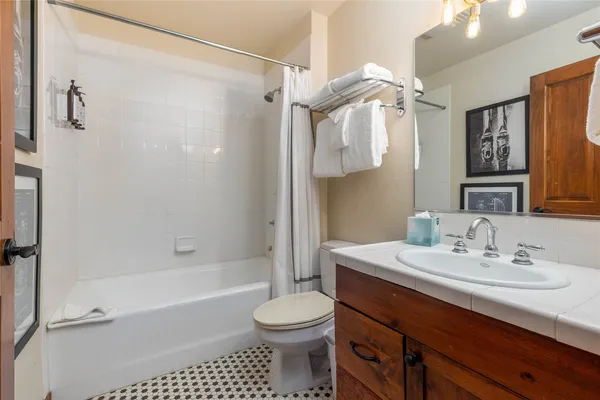 a spacious bathroom with a tub sink and mirror