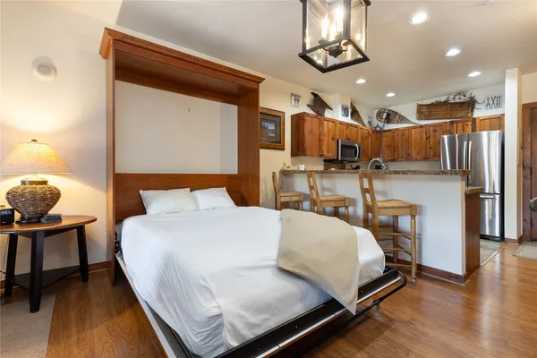 a bed sitting in a bedroom next to a window