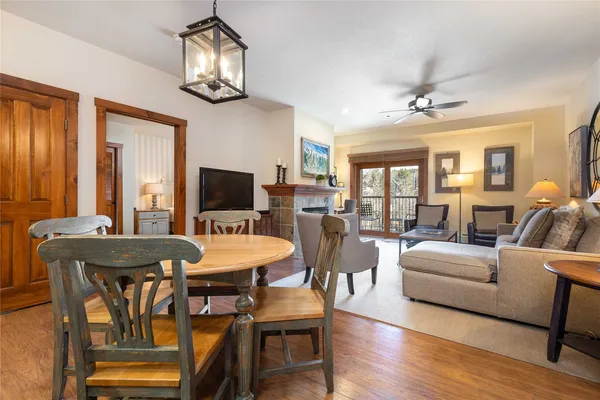 a view of a dining room with furniture a chandelier and wooden floor