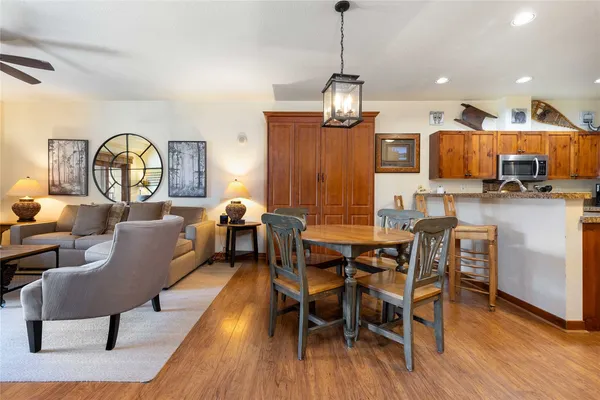 a view of a dining room with furniture a chandelier and wooden floor