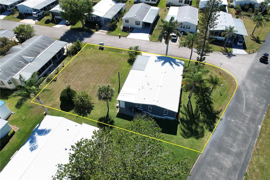 an aerial view of a house with a yard and potted plants