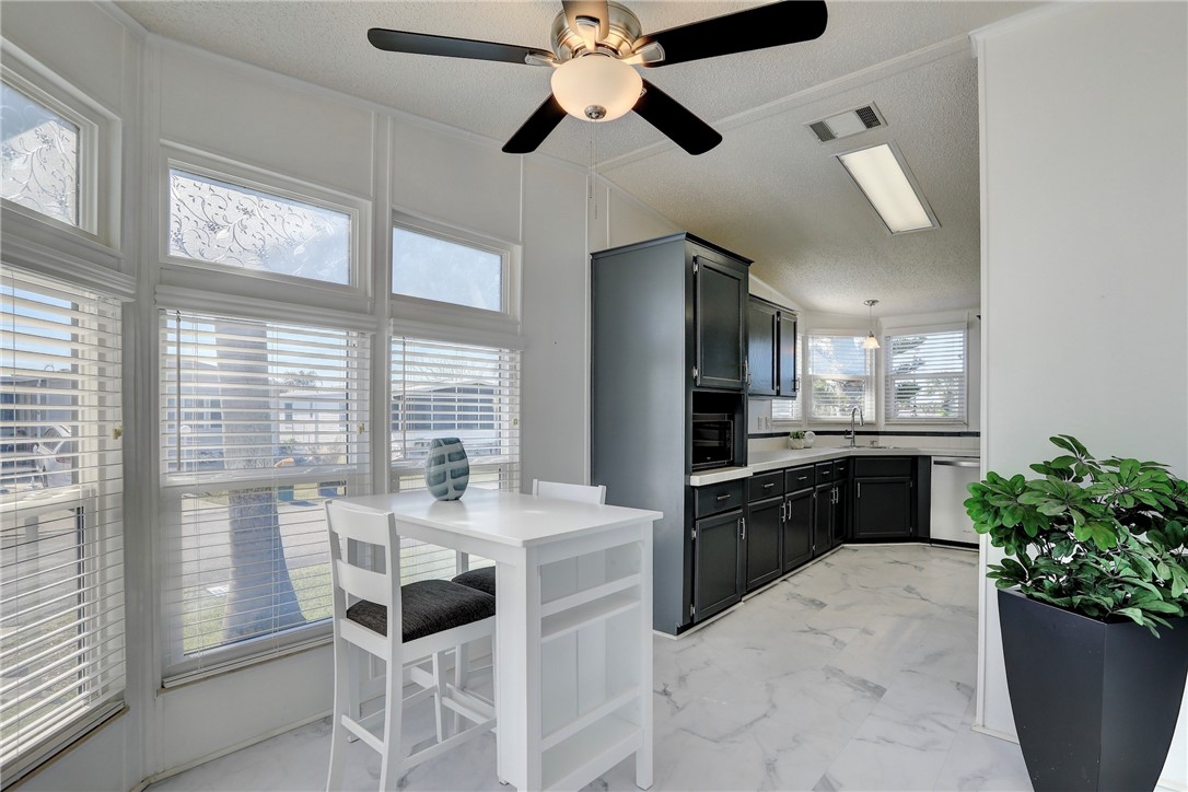 7519 Chasta Road Micco, FL 32976 - Photo 11 of 27 a large kitchen with a table and chairs