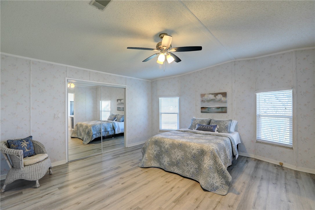 7519 Chasta Road Micco, FL 32976 - Photo 12 of 27 a bedroom with a bed and a couch