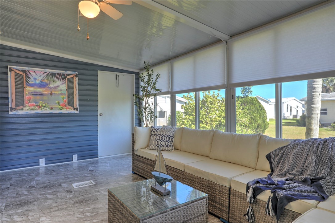 7519 Chasta Road Micco, FL 32976 - Photo 20 of 27 a living room with furniture and a large window