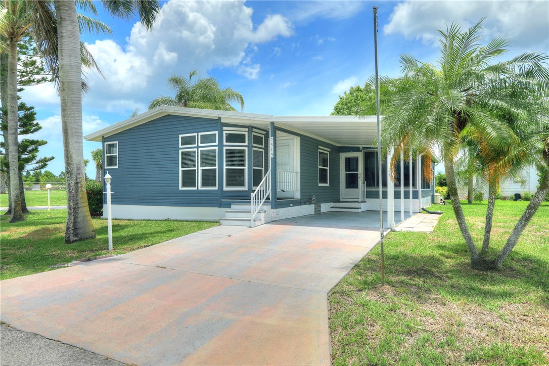 7519 Chasta Road Micco, FL 32976 - Photo 2 of 27 a view of a house with a yard and potted plants